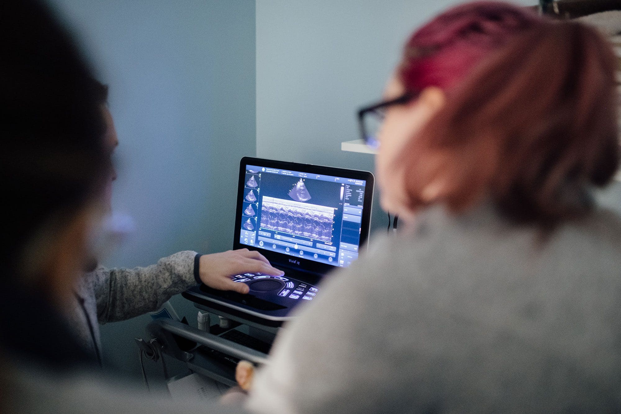technicians looking at screen with cardiology scans