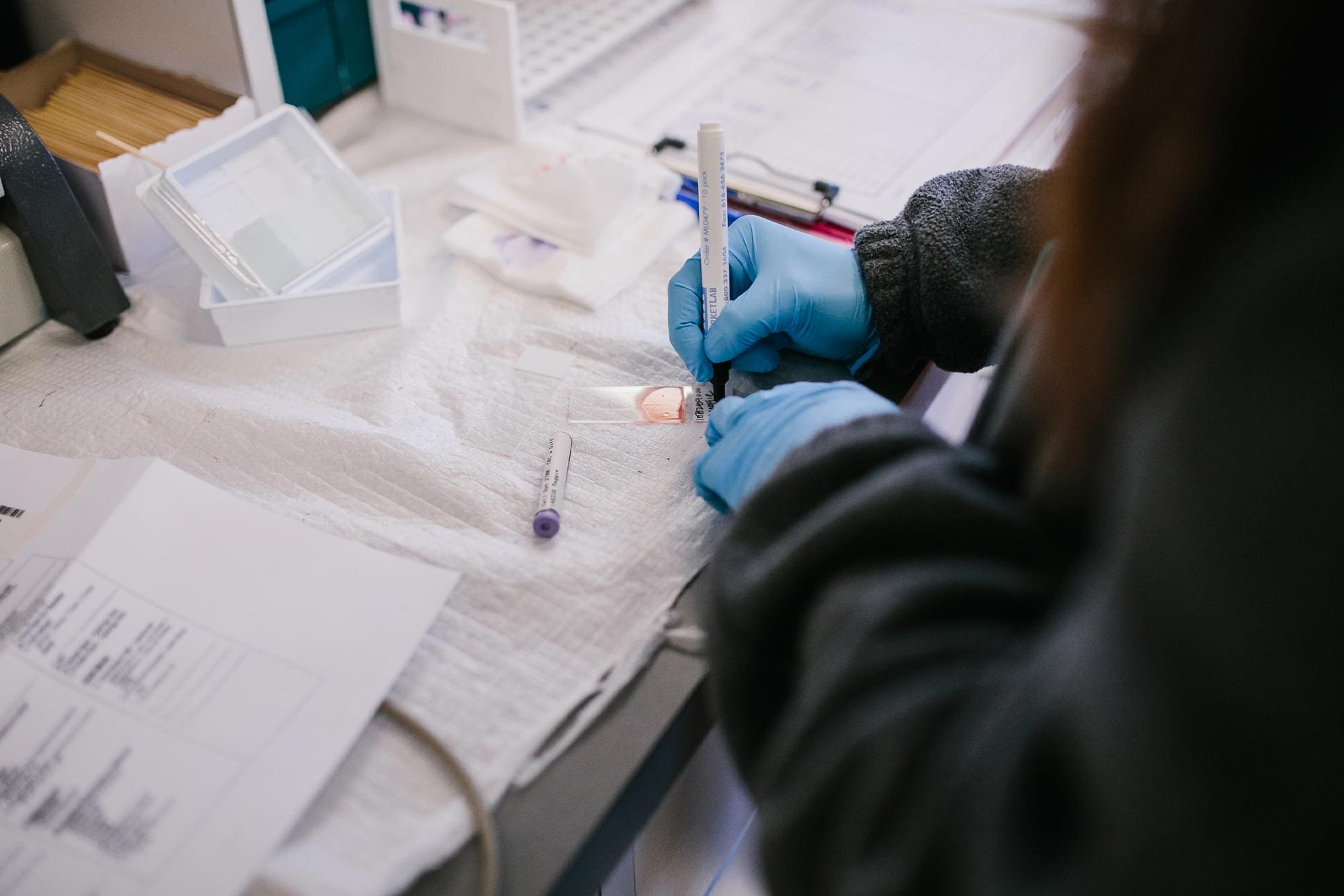 close up of staff member working in diagnostic lab