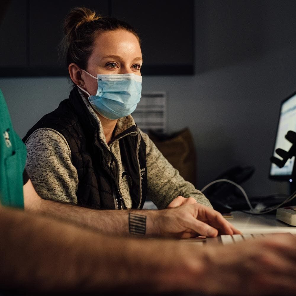 Doctor Wearing Mask And Looking At Ct Scans Doctor Wearing Mask And Looking At Ct Scans
